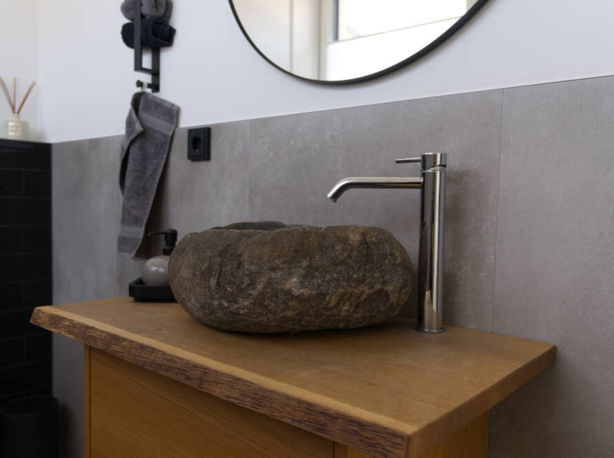 Detailaufnahme eines Naturstein-Waschbeckens im Gäste-WC
